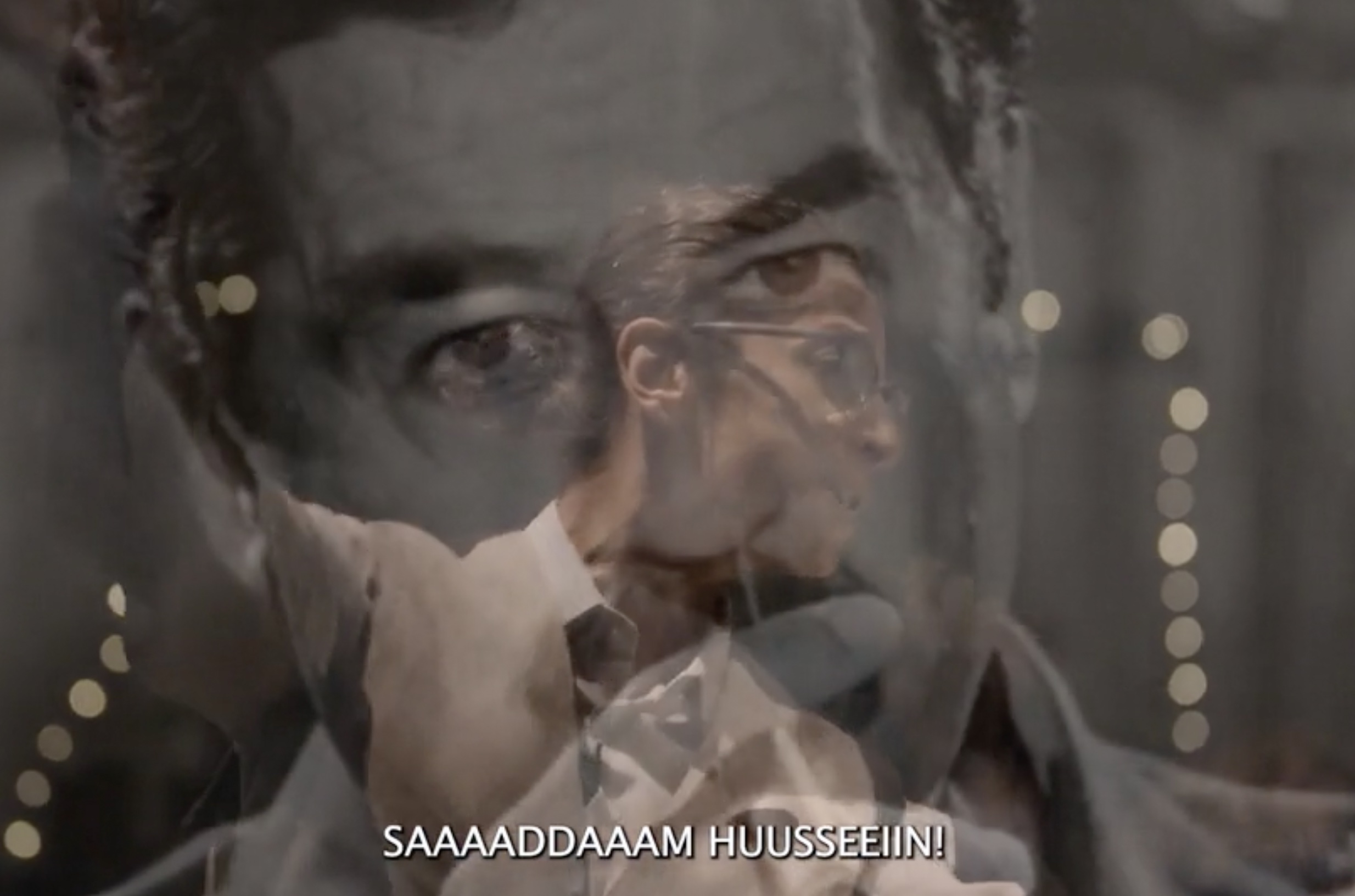 actor speaking with image of Saddam Hussein overlaid